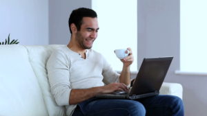 man at home working on laptop